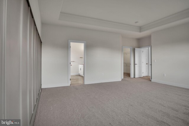 corridor with light colored carpet and a chandelier