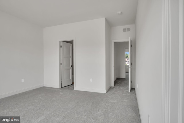 unfurnished bedroom featuring light colored carpet