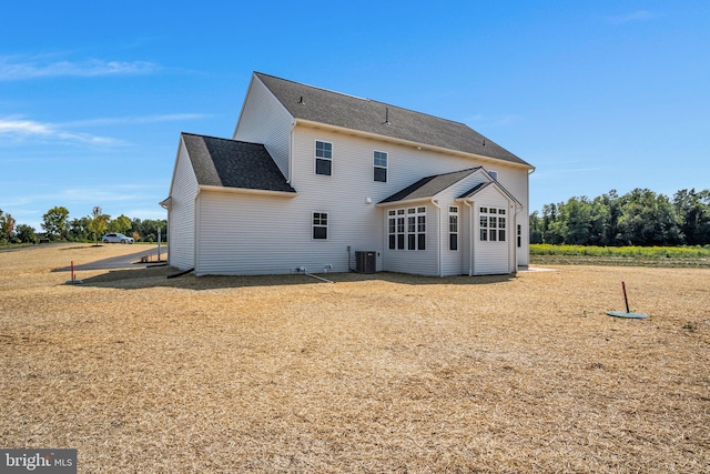 rear view of property with central AC