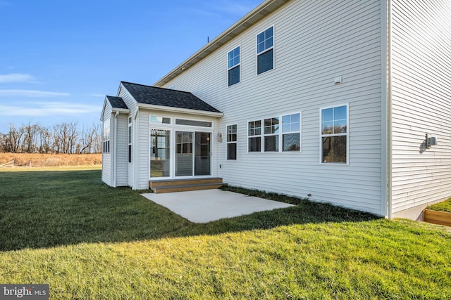 back of property featuring a yard and a patio area