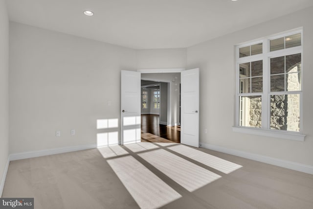 carpeted empty room with french doors