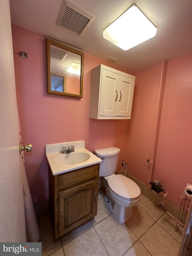 bathroom with tile patterned flooring, toilet, and vanity