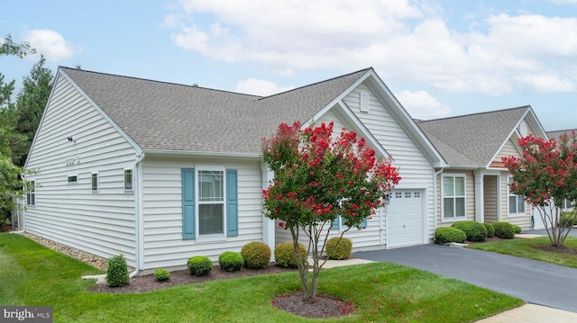 view of front of property with a garage and a front lawn