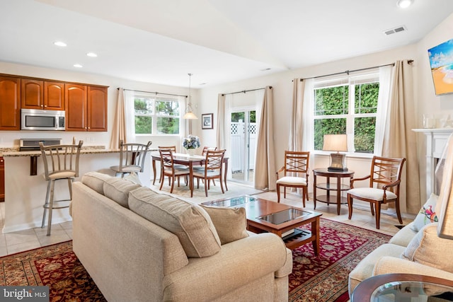 living room featuring light tile patterned floors and a wealth of natural light