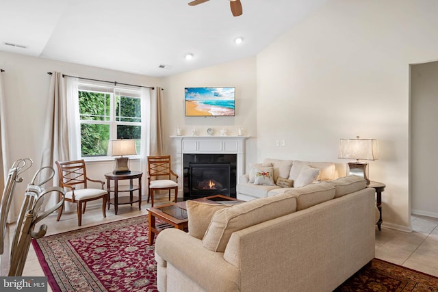 tiled living room with ceiling fan and vaulted ceiling