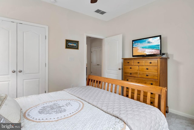 carpeted bedroom featuring ceiling fan and a closet