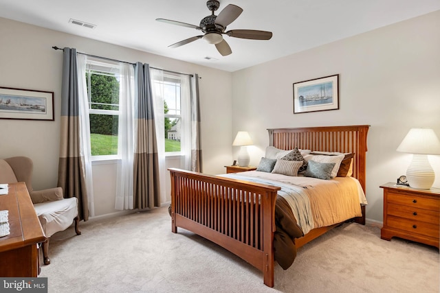 bedroom with ceiling fan, multiple windows, and light colored carpet