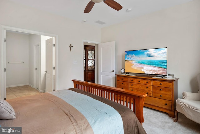 tiled bedroom featuring ceiling fan