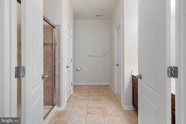 interior space featuring walk in shower, tile patterned floors, and vanity