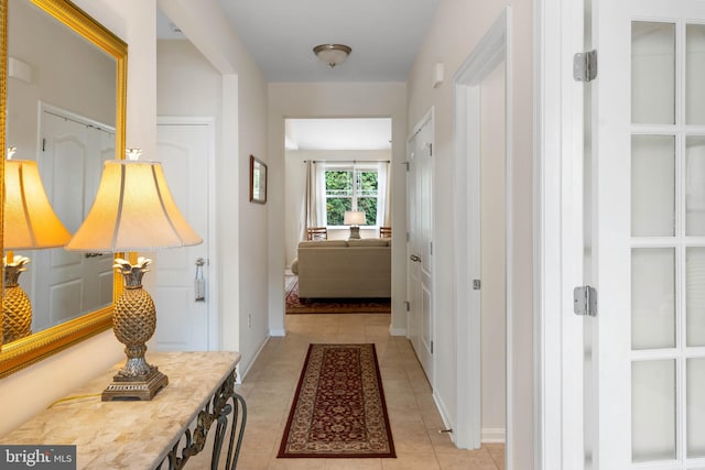 corridor featuring light tile patterned floors