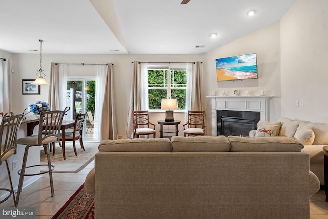 living room with light tile patterned floors and lofted ceiling