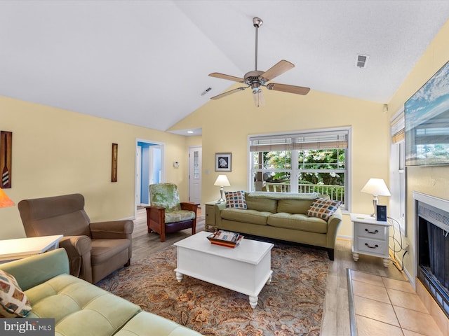 living room featuring ceiling fan, high vaulted ceiling, and hardwood / wood-style floors