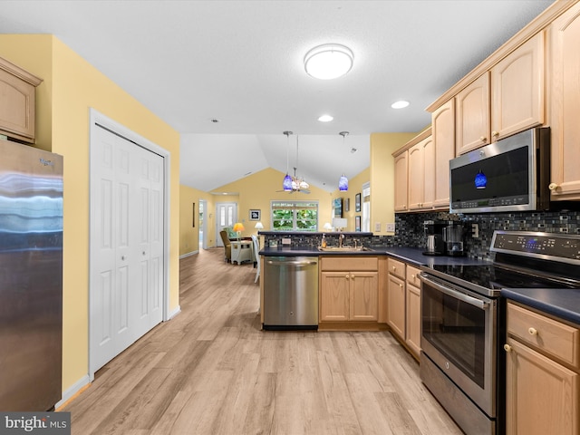 kitchen featuring hanging light fixtures, light brown cabinets, appliances with stainless steel finishes, kitchen peninsula, and decorative backsplash