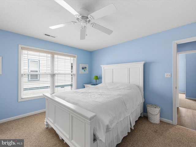 bedroom with light carpet and ceiling fan