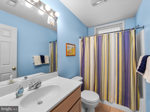 full bathroom featuring tile patterned floors, toilet, a textured ceiling, vanity, and shower / bath combination with curtain