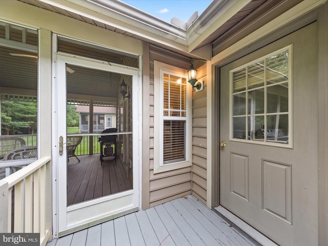 view of exterior entry featuring a wooden deck