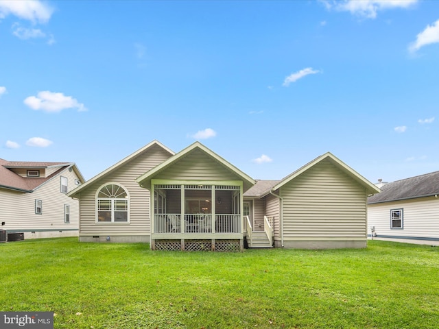 back of house with a yard and a sunroom