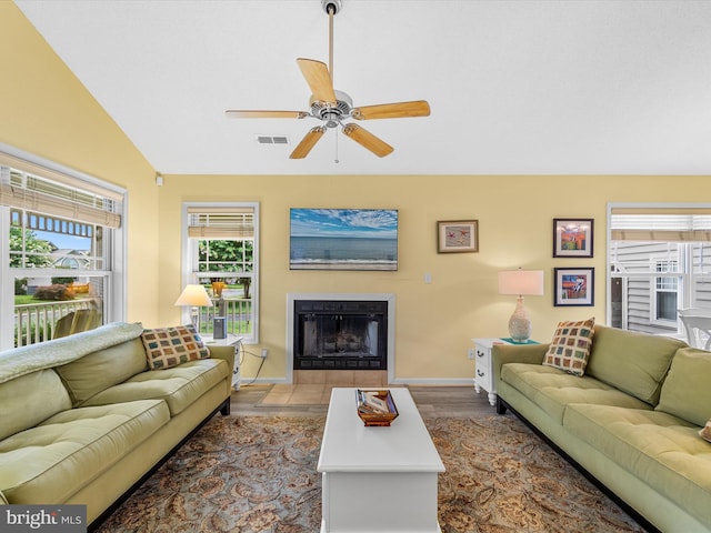 living room featuring ceiling fan, a wealth of natural light, wood-type flooring, and vaulted ceiling