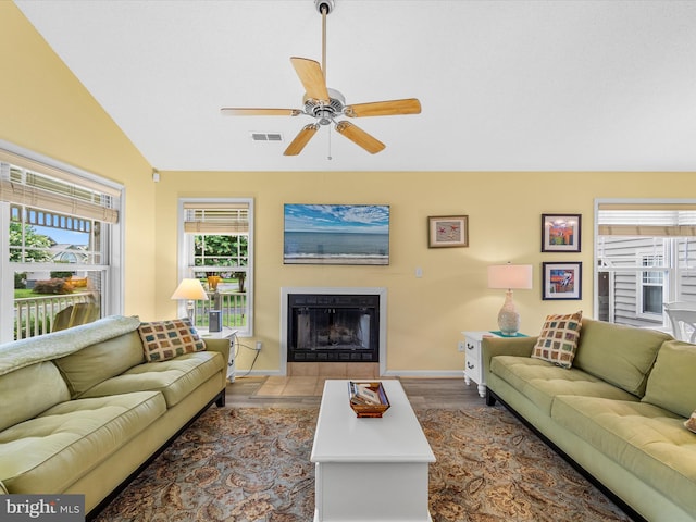 living room featuring ceiling fan, wood-type flooring, and lofted ceiling