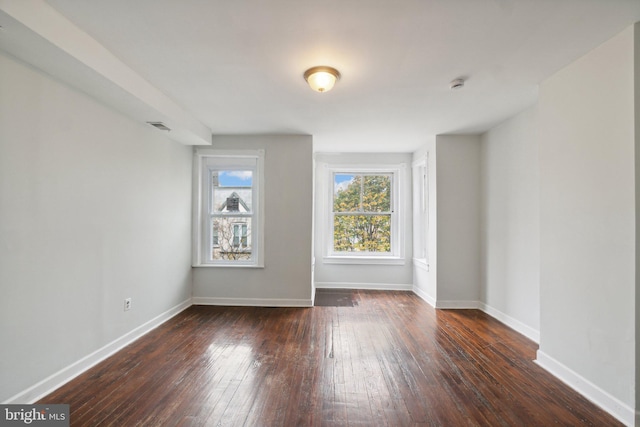 spare room with dark hardwood / wood-style flooring