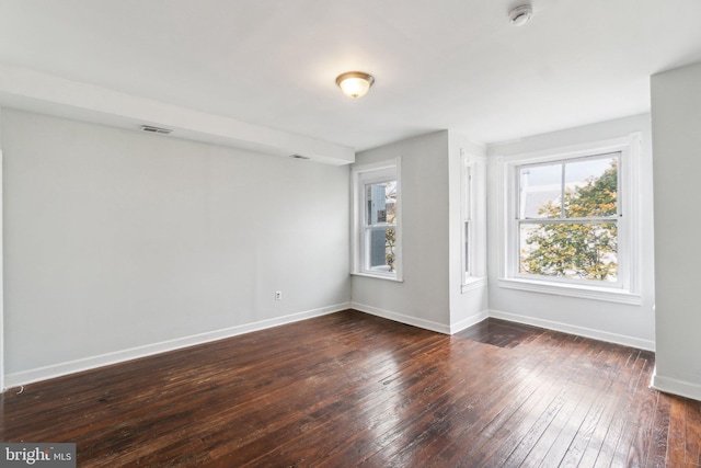 spare room with dark hardwood / wood-style floors