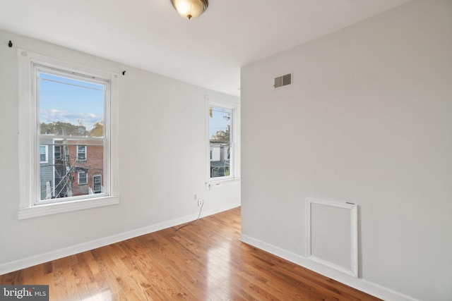 empty room with light hardwood / wood-style floors