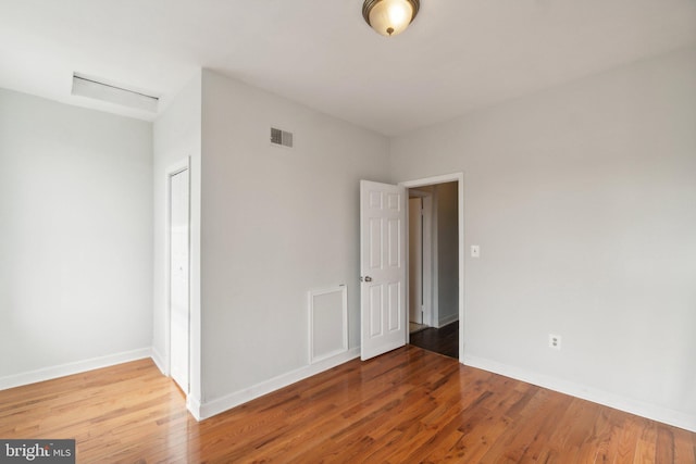 empty room with hardwood / wood-style floors