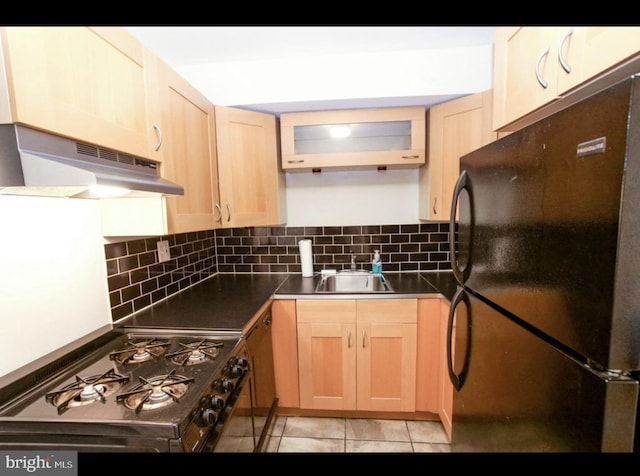 kitchen with sink, black appliances, tasteful backsplash, light tile patterned floors, and ventilation hood