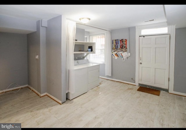 washroom with independent washer and dryer and light hardwood / wood-style floors