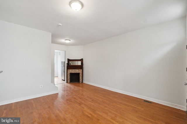 unfurnished living room with wood-type flooring