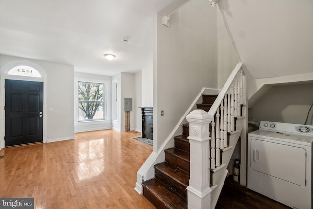 foyer entrance with hardwood / wood-style flooring and washer / dryer