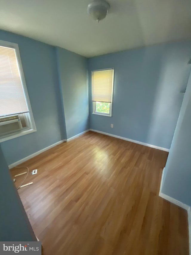 spare room with hardwood / wood-style floors