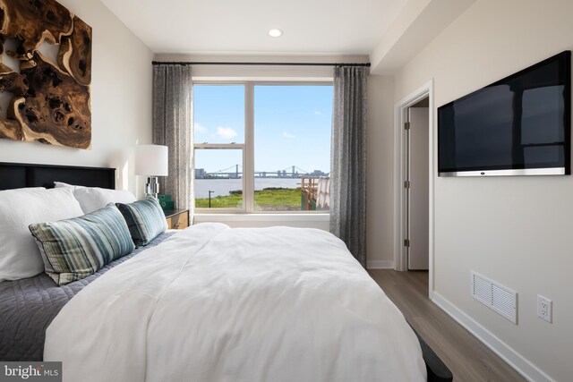 bedroom with hardwood / wood-style flooring