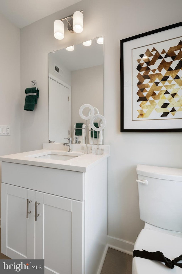 bathroom featuring vanity and toilet