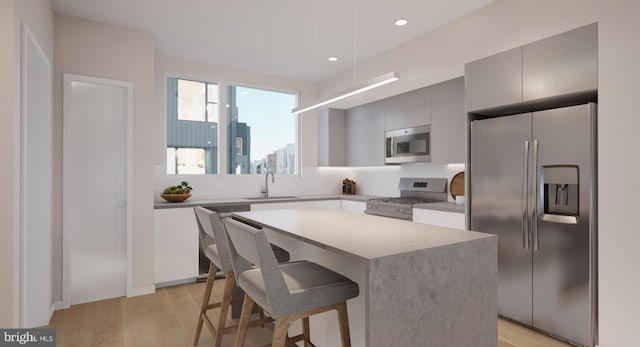 kitchen featuring sink, light hardwood / wood-style flooring, a kitchen island, and high quality appliances