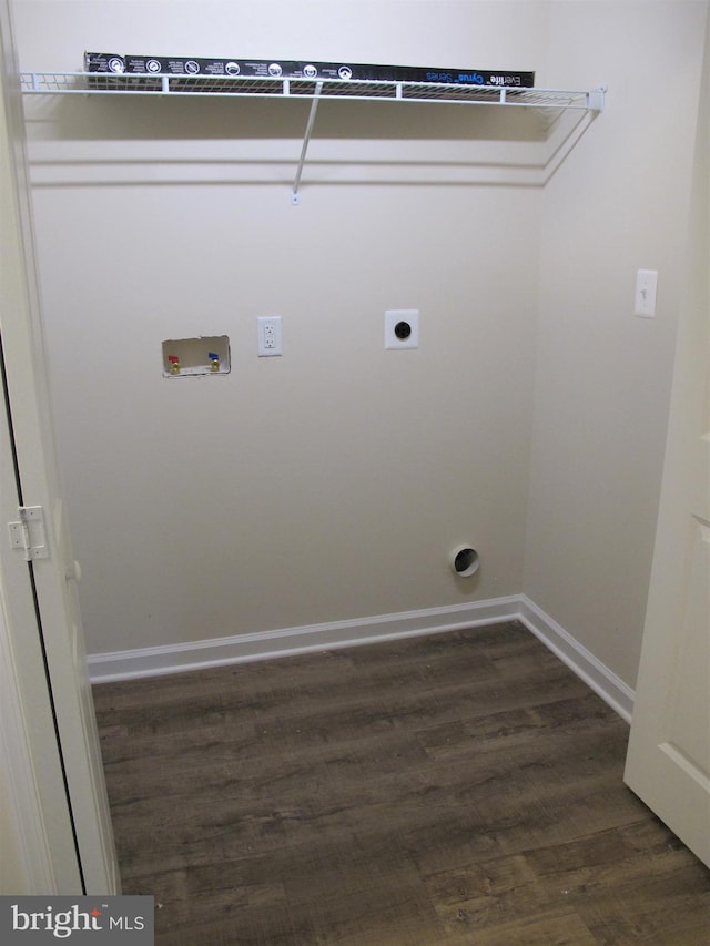 washroom with dark hardwood / wood-style flooring, hookup for an electric dryer, and washer hookup