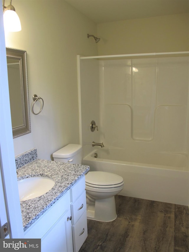 full bathroom featuring shower / bathtub combination, vanity, toilet, and hardwood / wood-style floors