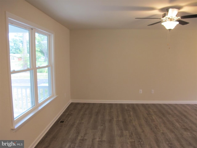 unfurnished room with ceiling fan and dark wood-type flooring