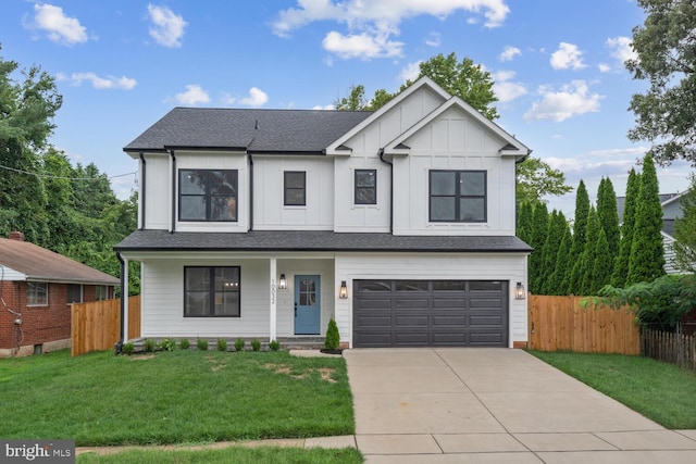 view of front of home featuring a front yard and a garage