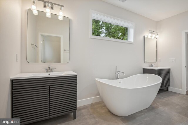 bathroom with vanity and a tub