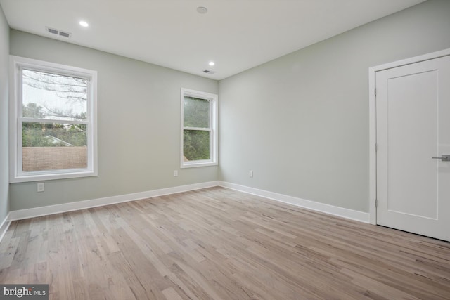 spare room with light hardwood / wood-style flooring