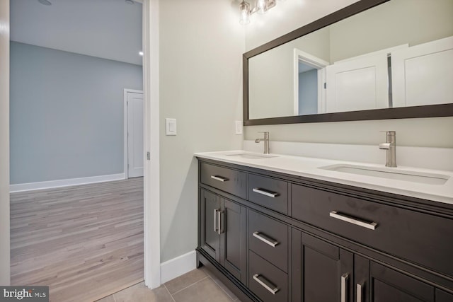 bathroom featuring double sink vanity and hardwood / wood-style floors