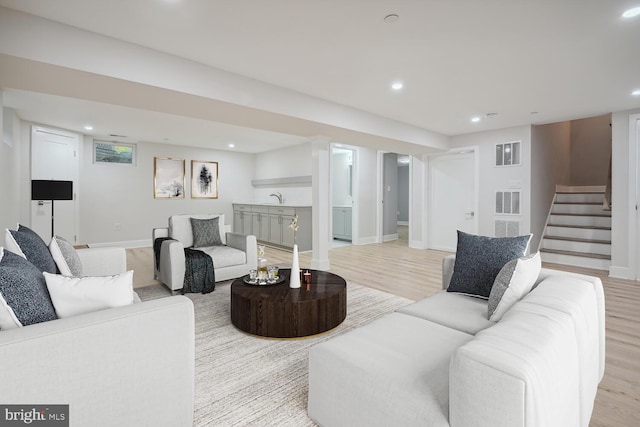 living room with sink and light hardwood / wood-style floors