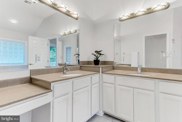 bathroom featuring vanity, vaulted ceiling, and tile patterned flooring