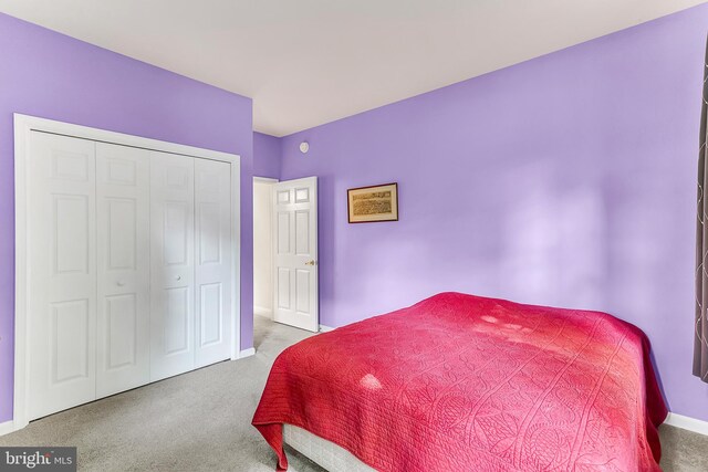 carpeted bedroom with a closet