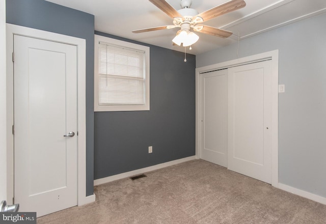 unfurnished bedroom featuring ceiling fan and light carpet