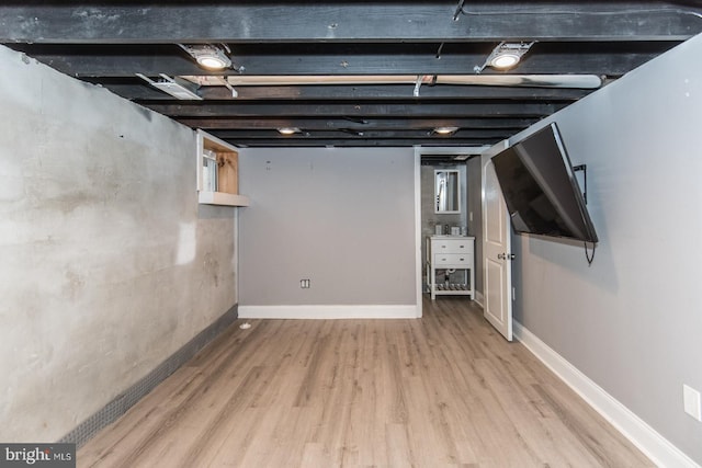 basement with light hardwood / wood-style floors