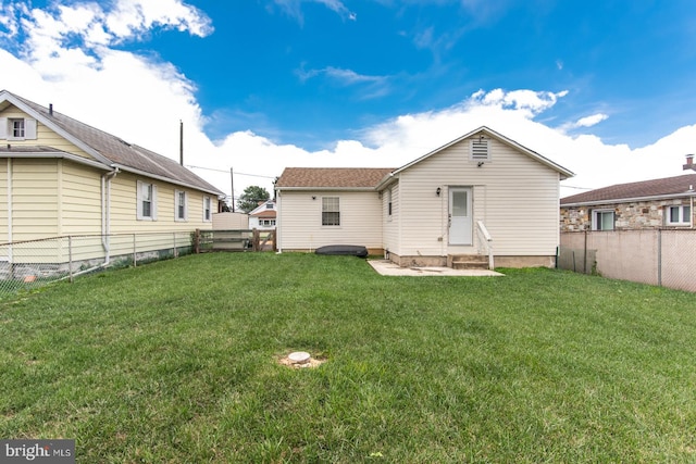 back of property featuring a lawn