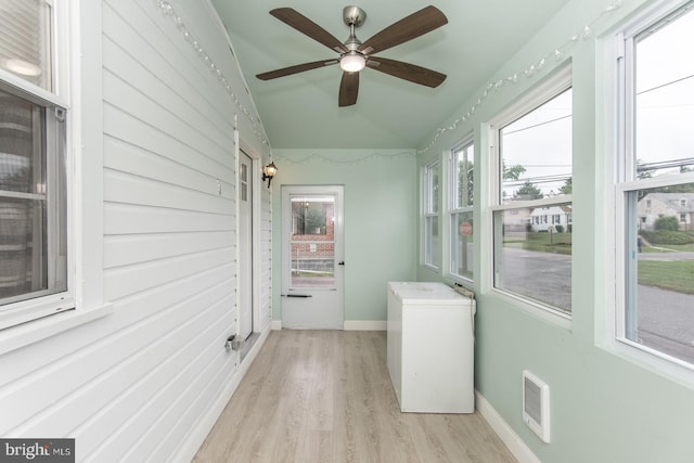 unfurnished sunroom featuring ceiling fan