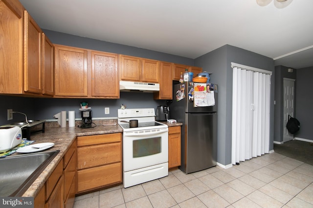 kitchen featuring light tile patterned floors, sink, stainless steel fridge, and white electric range oven